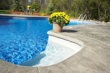 Flowerpot on edge of swimming pool