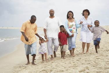 Three generation family walking together on the breach