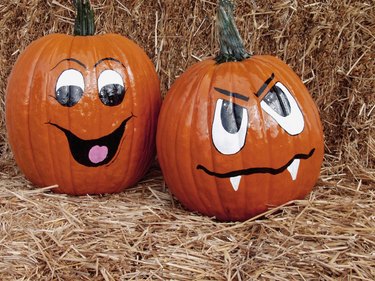 Faces painted on two pumpkins