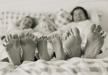 Family lying in bed