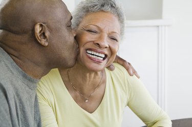 Man kissing woman on cheek