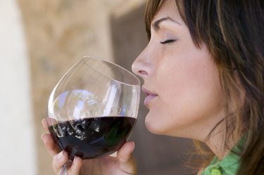 Woman smelling wine with eyes closed