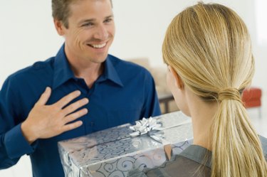 Woman giving gift to man