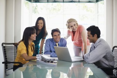 Smiling businesspeople with laptop computer