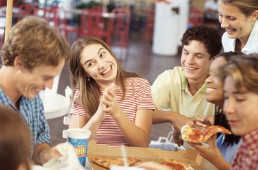 Group of teenagers smiling in a restaurant