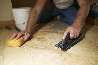 Hands of marble mason scraping floor