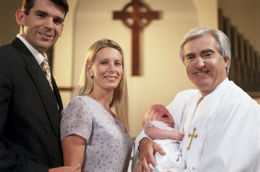 Close-up of parents with their son at a baptism