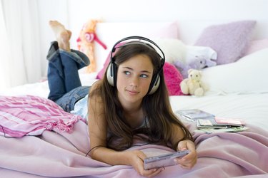 Teenage girl listening to music on her headphones