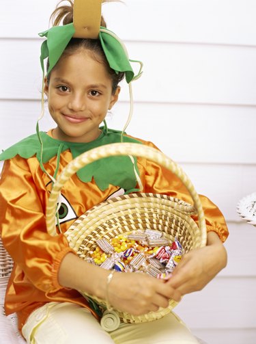 Young girl costumed as a pumpkin