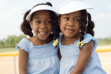 Twin girls embracing