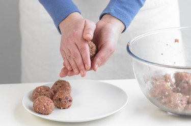 Person making meatballs, close up