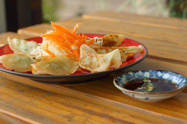 Gyoza in a red plate on a table