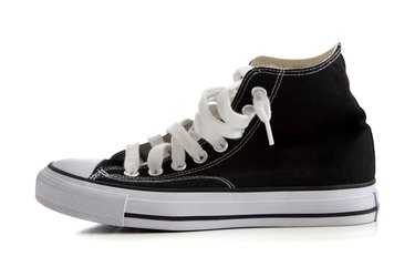 Black high top sneakers on white
