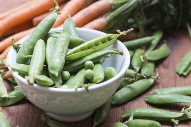 Pea pods in a bowl with carrots