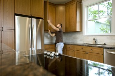 Contractor working on cabinets in new home