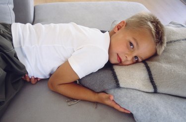 Boy lying down on blanket