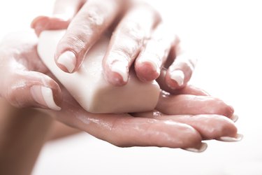 Woman washing hands with bar of soap