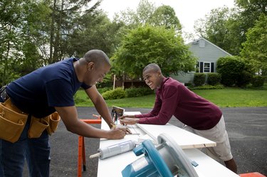 Father and son working on house