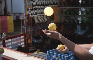 Person juggling balls at carnival