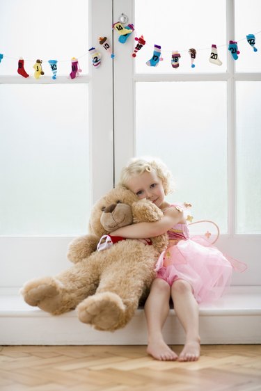 Girl hugging teddy bear