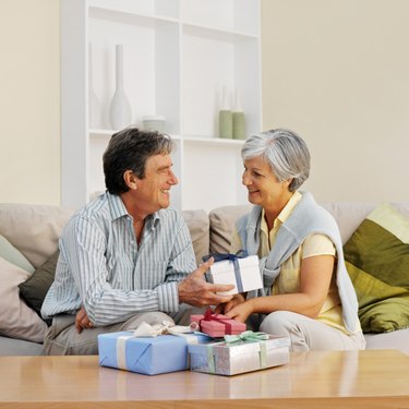 Side view of a mature man giving mature woman a gift