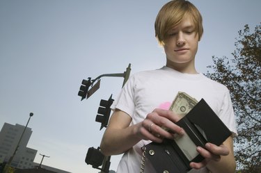 Teenage boy looking in wallet