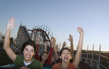 People riding on roller coaster
