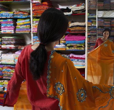 Woman selecting sari in sari shop