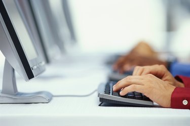 two business executives using computers in an office