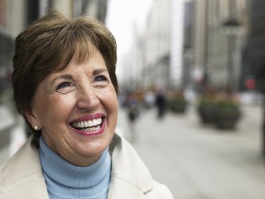 Senior woman standing on sidewalk