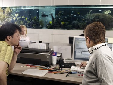 two young men looking at the computer screen