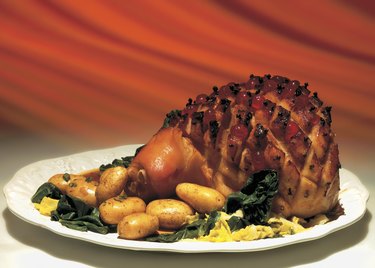 close-up of a roast served with potatoes and green on a platter