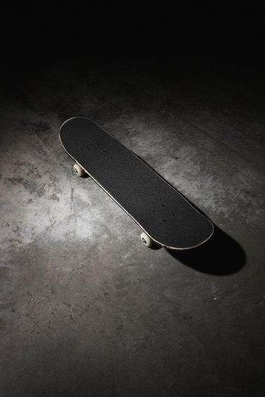 Skateboard on concrete floor, elevated view