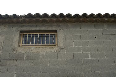Window with bars on cinder block building