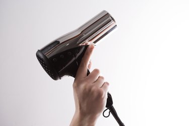 Woman holding hairdryer