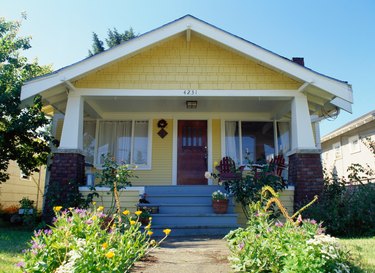 Yellow bungalow style house with garden, exterior view