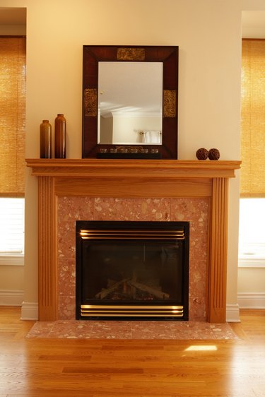Fireplace with decorative vases and mirror