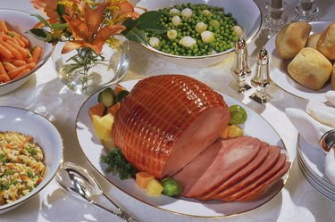 Table with baked ham and other dishes