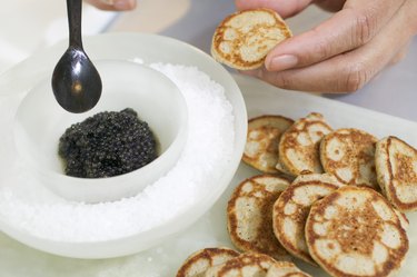 Preparing caviar canapes