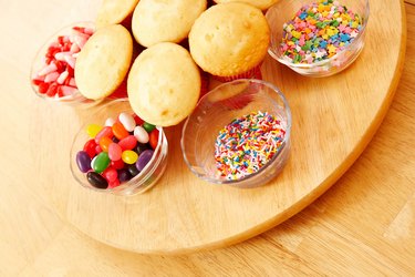 Cupcakes and bowls of candies on lazy susan