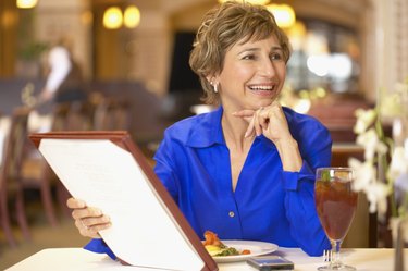 Woman with a menu at a restaurant
