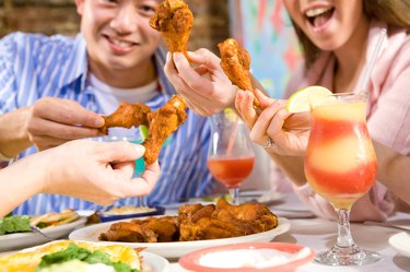 Party of people eating hot wings