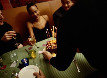 Woman Receiving a Cake at a Birthday Party
