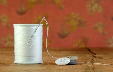 Spool of Blue Thread with Needle and Buttons