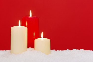 Three Christmas candles red background