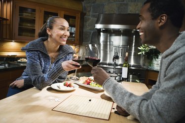 A couple toasting with red wine