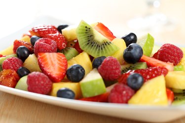 cut fruit salad on white plate