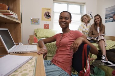 Young women smiling in dorm room, portrait, close-up