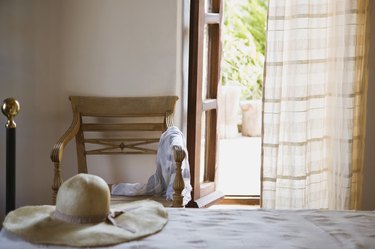 Hat on bed by open window