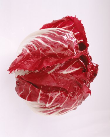 Radicchio leaf against white background, close-up